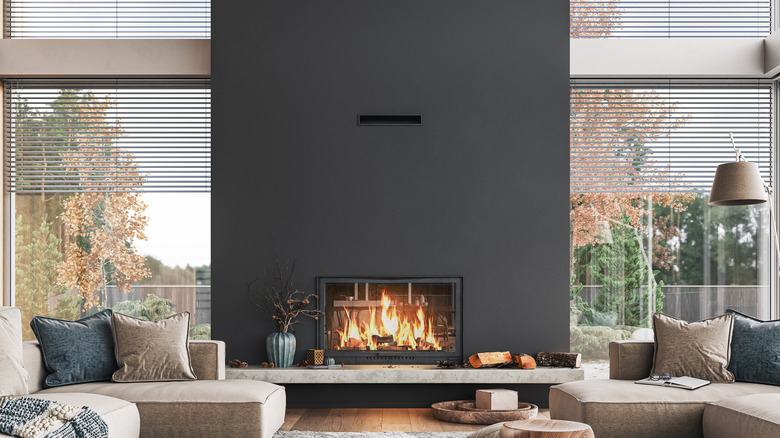 Black plaster wall with modern fireplace