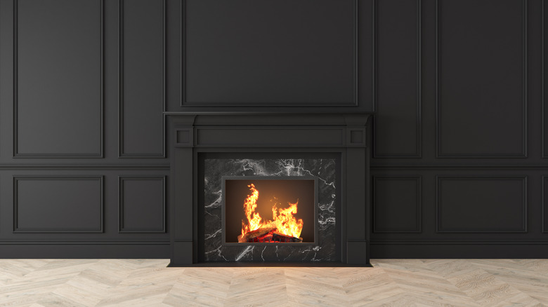 Black fireplace on black wall paneling
