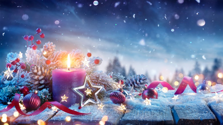 Purple candle in snow