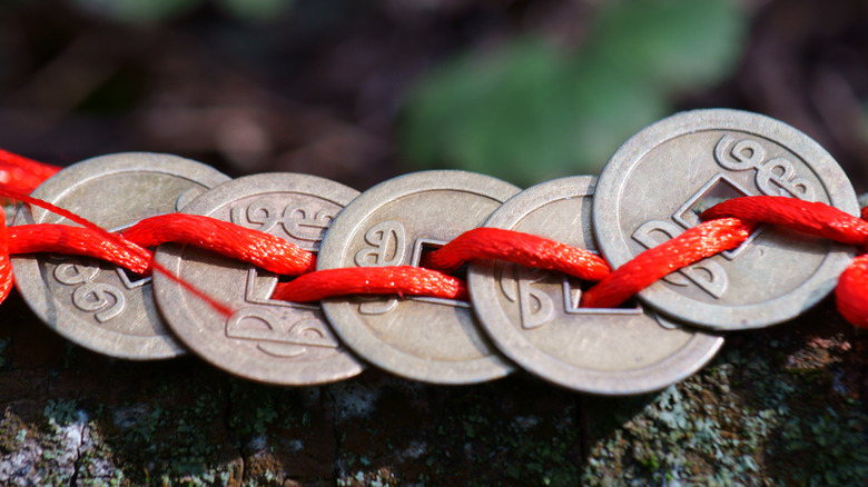 chinese coins in red ribbon