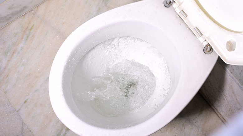 Toilet bowl water splashing