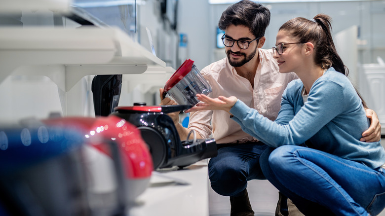 Young couple examining vacuum container