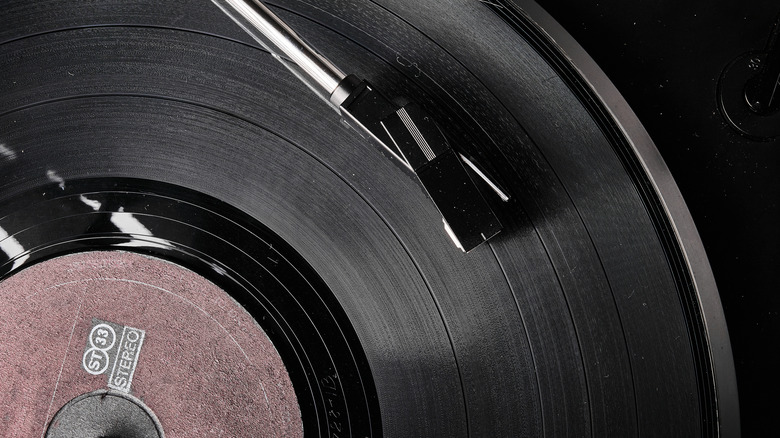 Closeup of record on turntable with needle resting on surface.