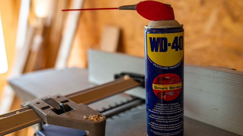 A can of WD-40 sitting on a work table