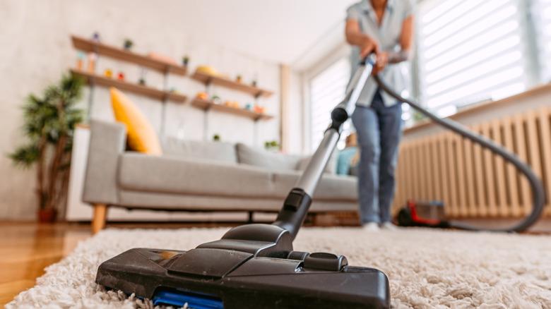 Person vacuuming carpet 