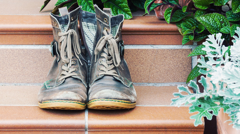 worn work boots on doorstep