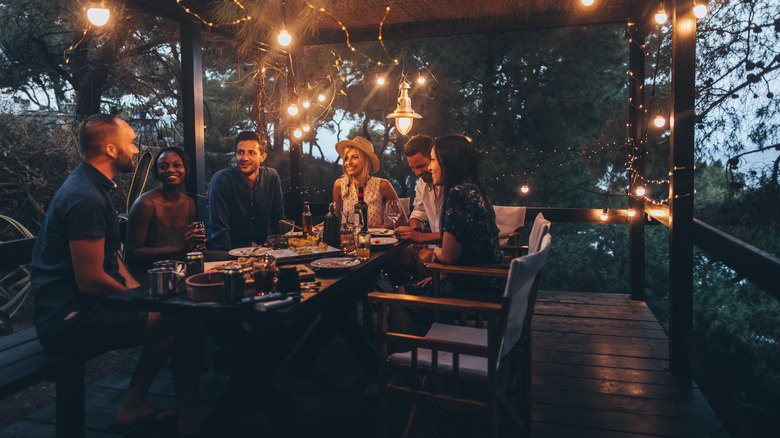 Friends enjoying evening on patio