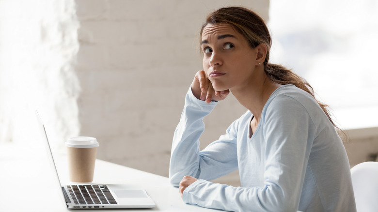 college student anxious at laptop