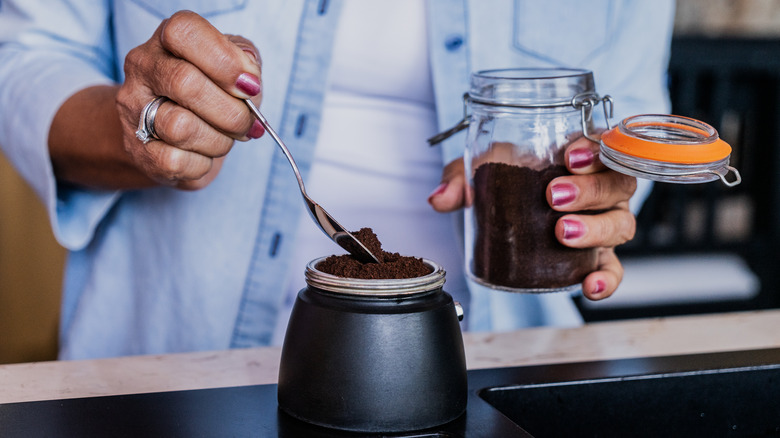 person making coffee