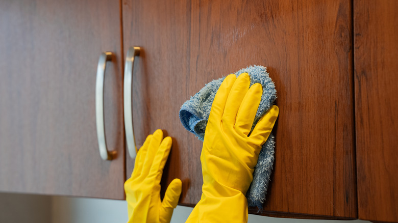 wiping wooden cabinet