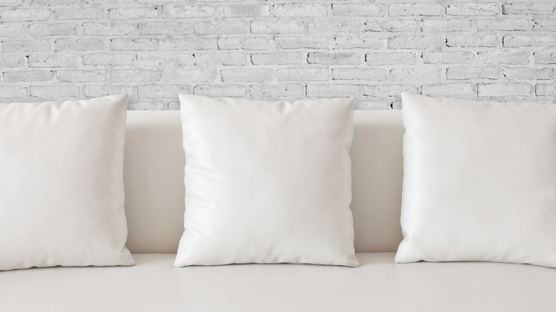 White pillows on white sofa