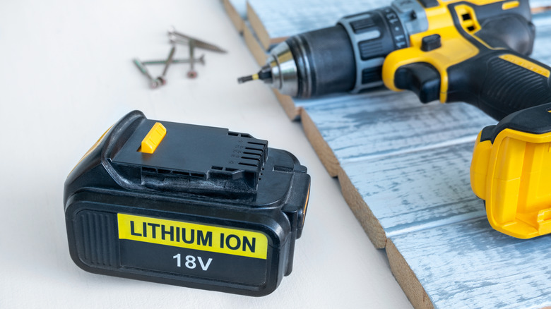 Power drill next to rechargeable battery