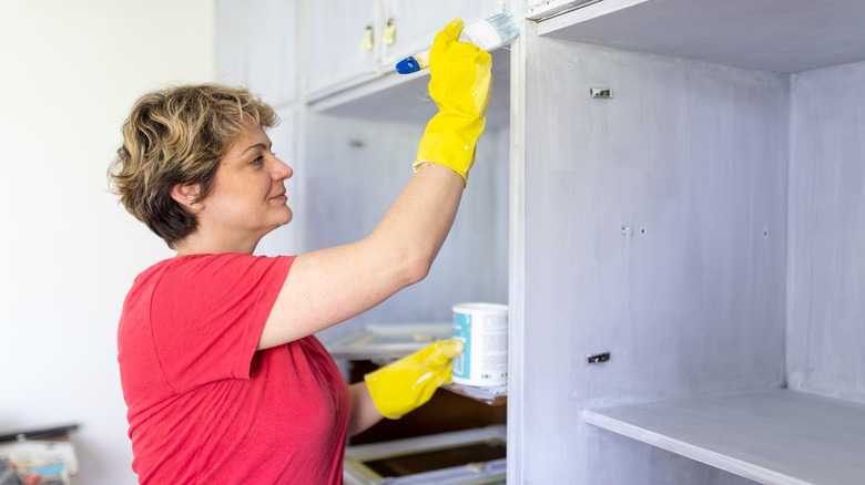 Woman painting cabinets