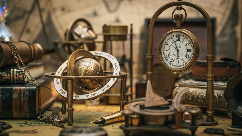 Antique brass globe and an old clock