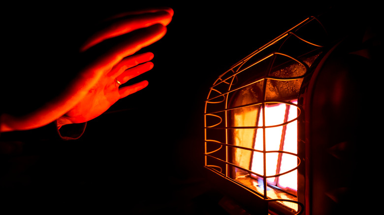 Glowing heater with hand reaching out