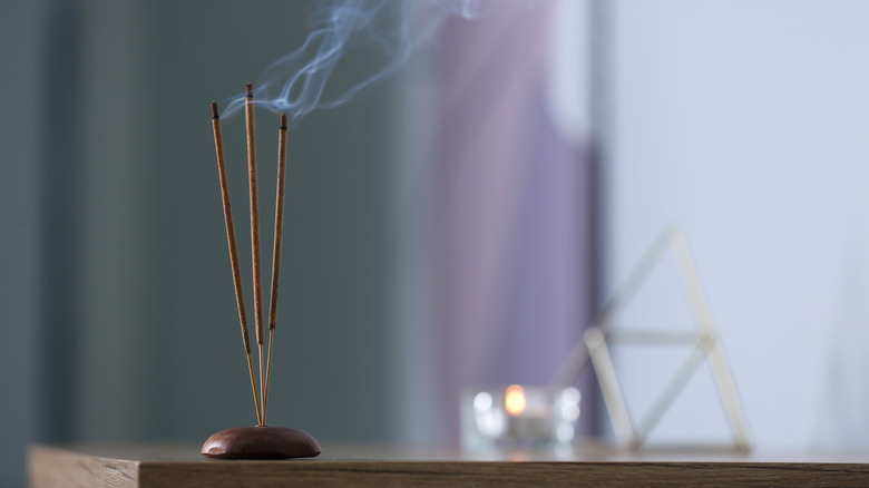 three sticks of incense burning