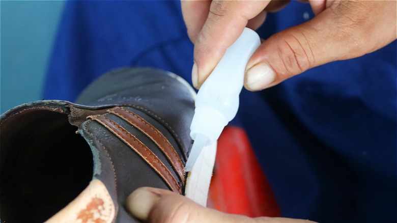 Person using super glue on shoes