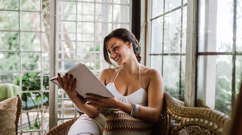 woman reading in sunroom