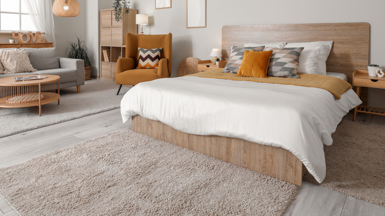 Bedroom with various furnishings in orange and neutral colors