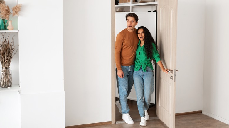 couple walking into apartment