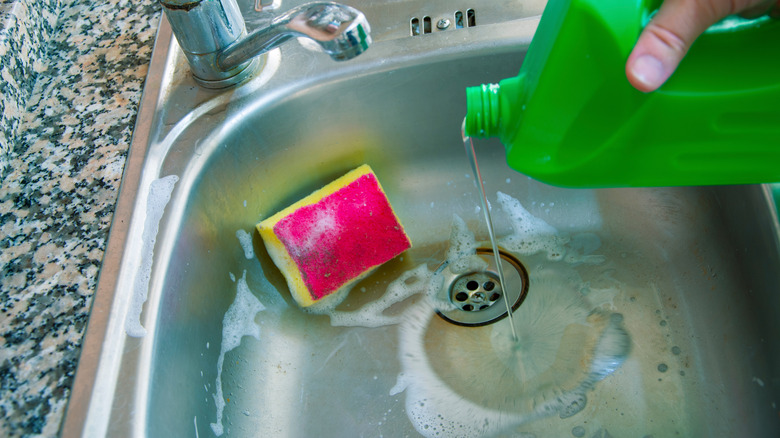 Pouring liquid in kitchen sink