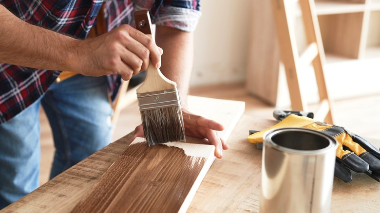Person working with wood stain