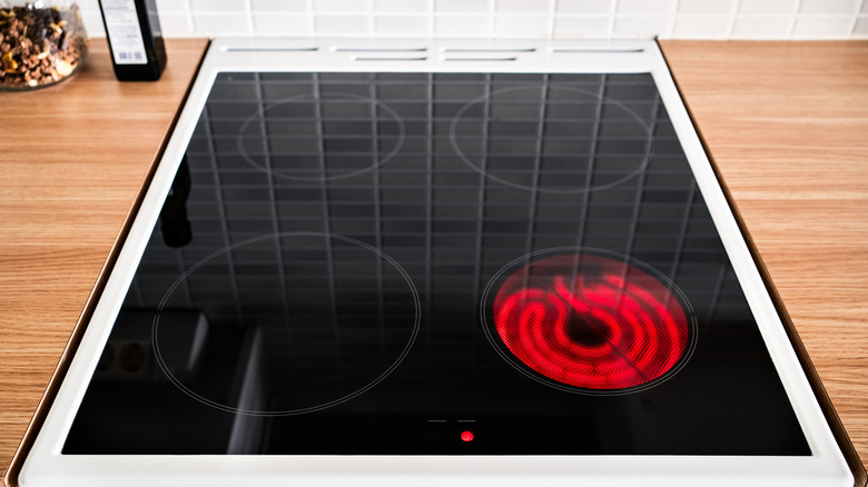 One burner on a glass-topped stove heats up.