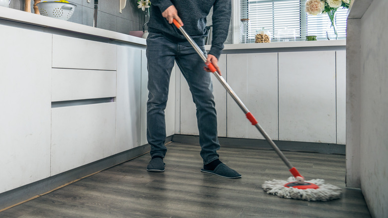 Person mopping kitchen floor 