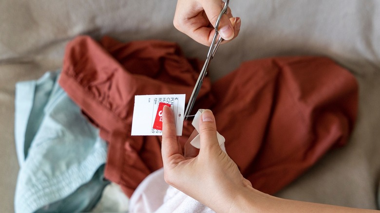 Person cutting tags off clothes