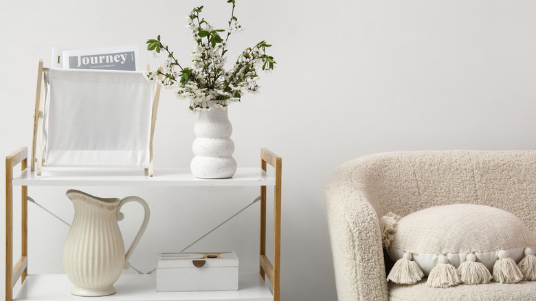 A magazine holder in a white living room