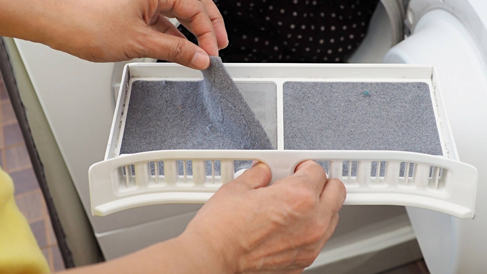 Why You Should Use A Toothbrush To Clean Your Dryer's Lint Trap