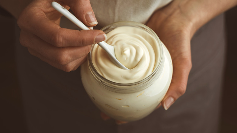 person stirring mayonnaise