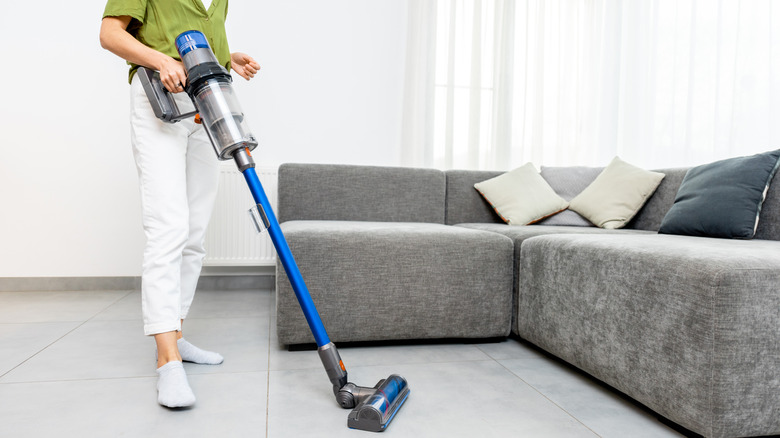 woman cleaning with cordless vacuum