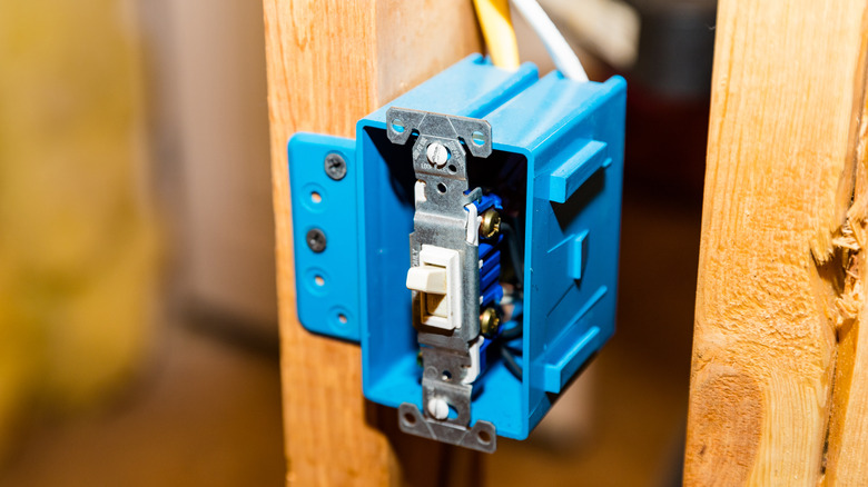 A sturdy blue plastic electrical switch box