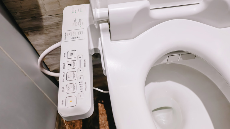 Bidet attachment on toilet seat