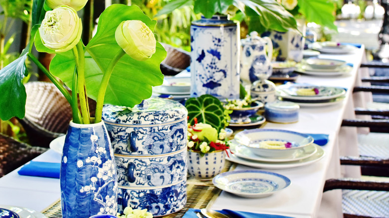 A table setting featuring a variety of blue-and-white chinoiserie style dishware.