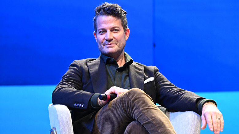Nate Berkus sitting against a blue background.