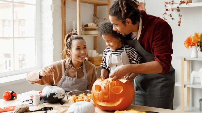 Family carving pumpkins