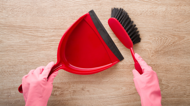 Sweeping floor with dustpan