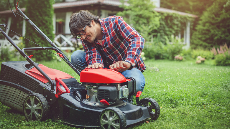 A man inspecting a new lawn mower