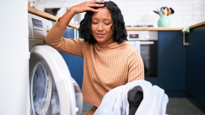 woman taking laundry out of dryer