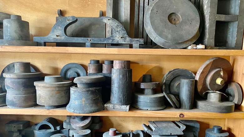 Shelves covered in heavy objects made of wood and metal