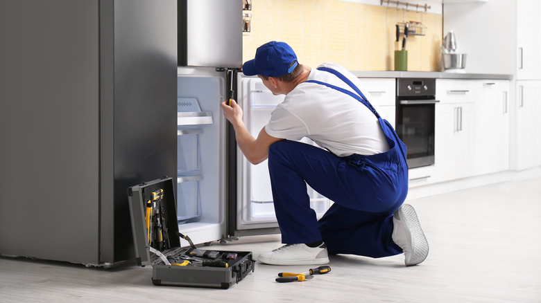 Man repairing fridge