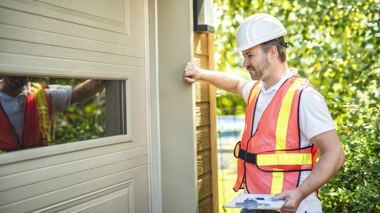 A man inspecting a garage door