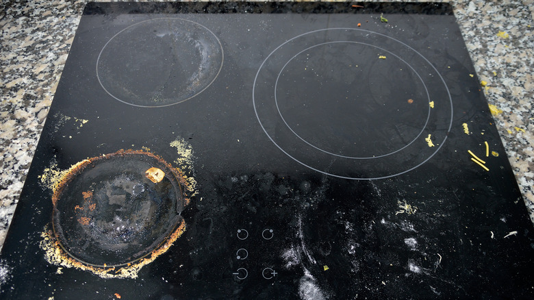 Dirty stove top with burnt-on mess