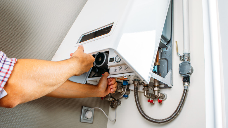 man checking heating unit