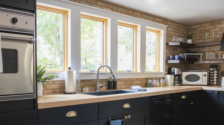 Four square windows outlined with brick backsplash