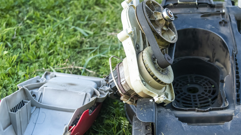 A closeup shot of a lawn mower under repair