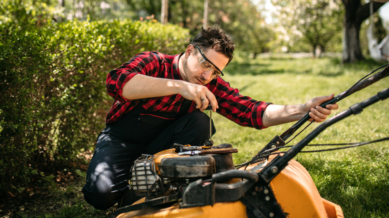 Someone inspecting their lawn mower