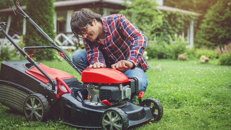 A man observing a lawn mower